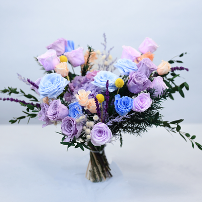 Lavender Sky Preserved Flower Bouquet hand-tied bouquet of blue and lavender roses, hydrangea, and eucalyptus without vase