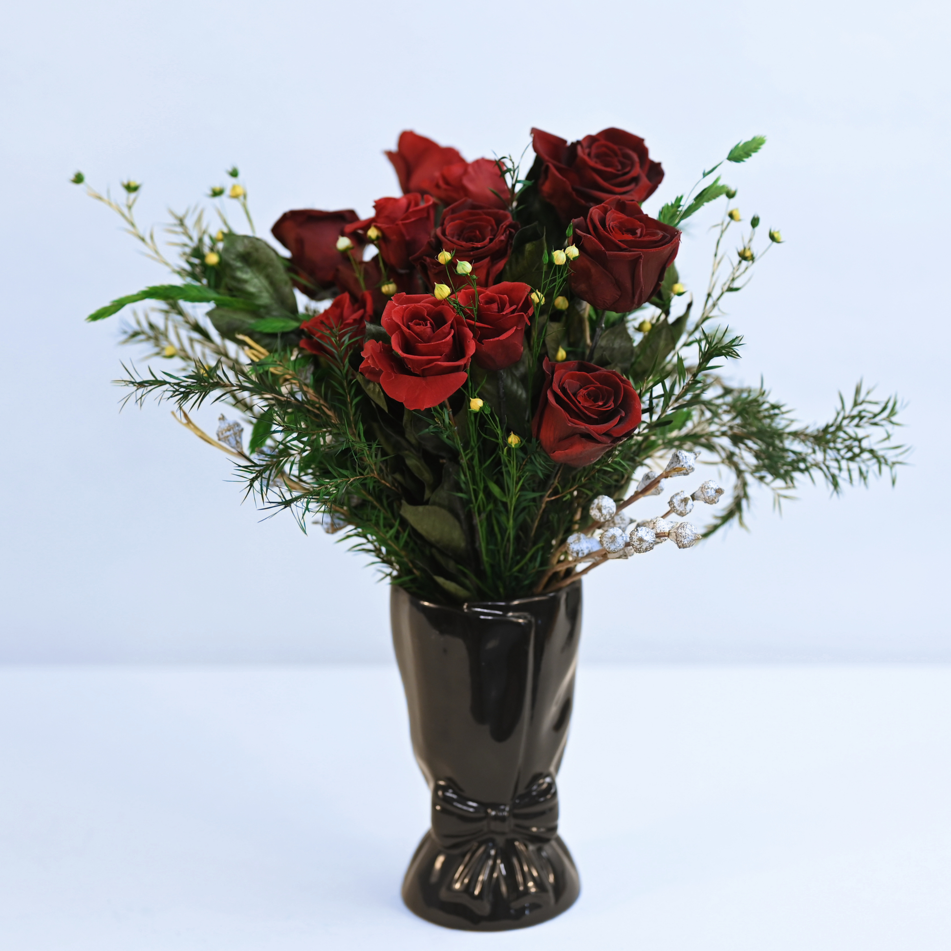 Velvet Rouge Preserved Rose Bouquet with wine-red roses and eucalyptus held in hand