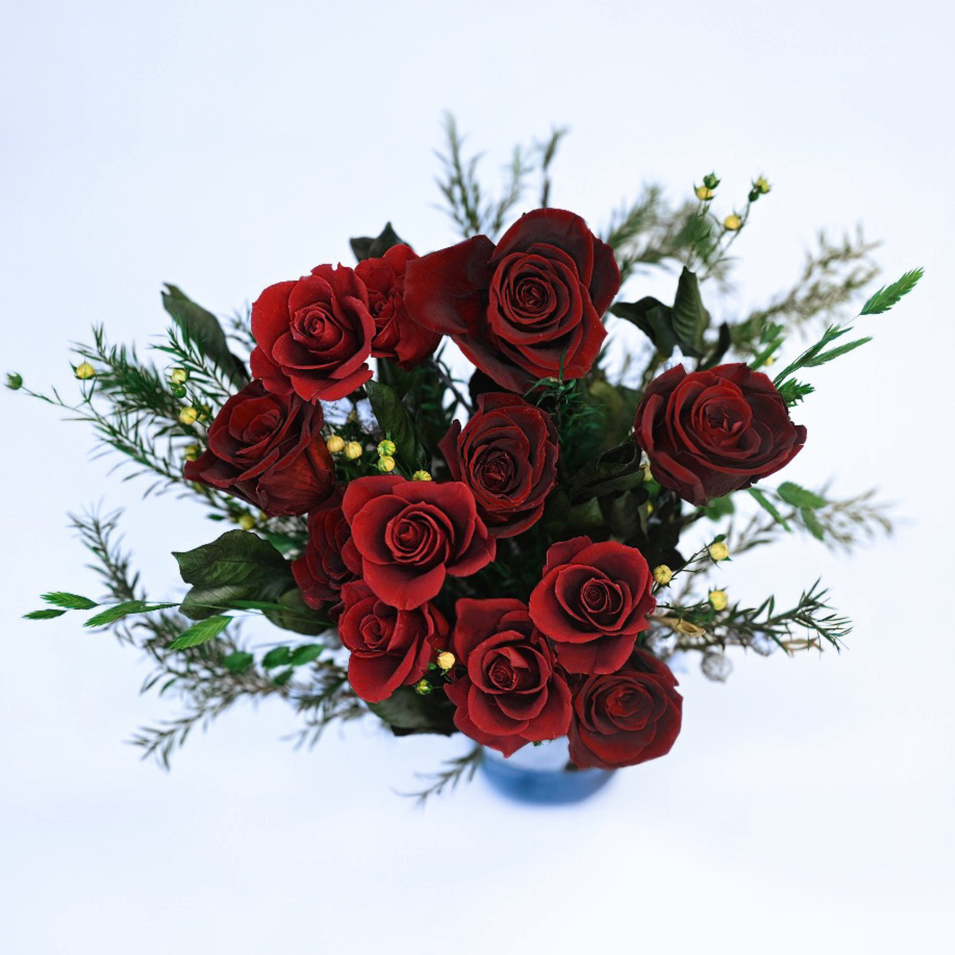 Aerial view of the Velvet Rouge Preserved Rose Bouquet showing wine-red roses with eucalyptus, ribbon grass, and acacia