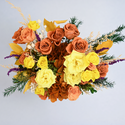 Aerial view of Golden Hour Preserved Flower Bouquet showing orange-red and golden roses, hydrangea, ruscus leaves and purple lavender