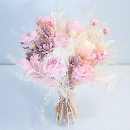 Blush Muse Preserved Flower Bouquet featuring pink and white roses, celosia, craspedia and cloud grass in soft blush and lavender tones, front view