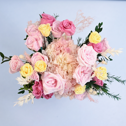 Aerial view of Coral Blush Preserved Flower Bouquet showing light pink, deep pink and yellow roses with blush hydrangea and asparagus fern