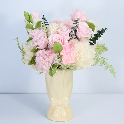 Rose Villa Preserved Flower Bouquet displayed in a cream ceramic bow vase, front view