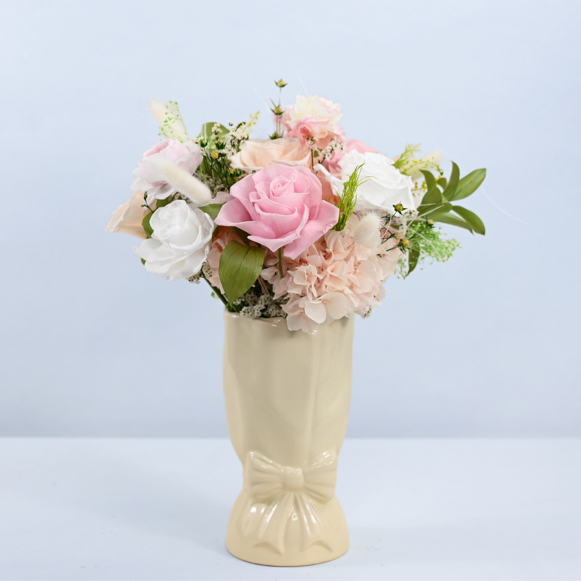 Rose Villa Petit Preserved Flower Bouquet displayed in a cream ceramic bow vase, front view
