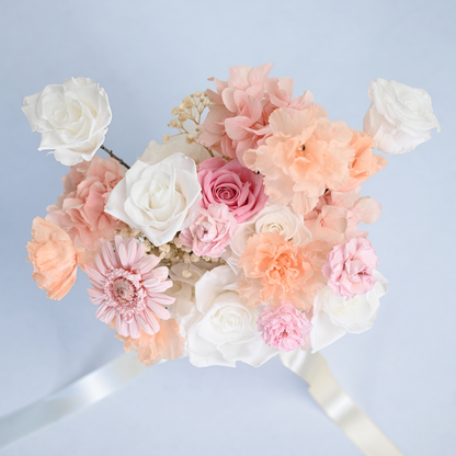 Aerial view of Blush Reverie Preserved Flower Bouquet featuring white roses, pink gerbera daisy, peach lisianthus, hydrangea and baby's breath