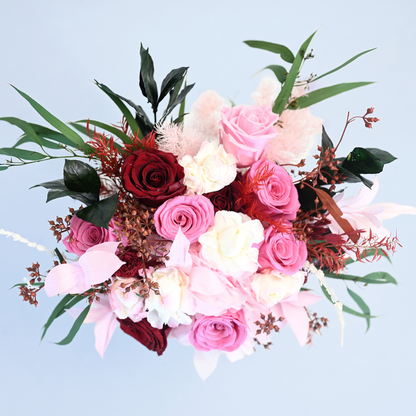 Aerial view of Crimson Blush Preserved Flower Bouquet showing crimson and pink roses, hydrangea, pink ruscus and eucalyptus