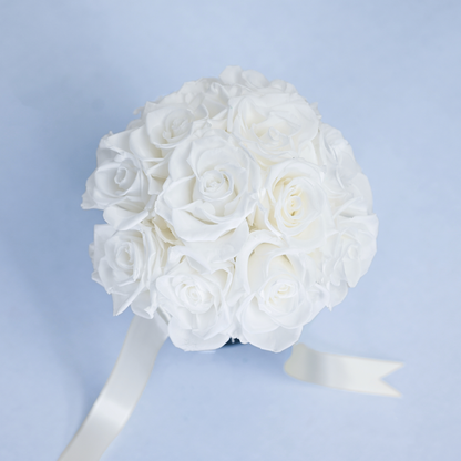 Close-up aerial view of Opal Preserved Rose Bouquet showing tightly arranged white preserved roses with cream satin ribbon