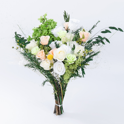 Opal Bloom Preserved Flower Bouquet standing upright showing full arrangement of white, cream and peach roses with abundant green foliage, front view