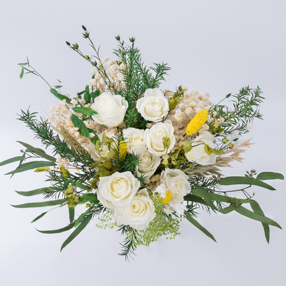 Aerial view of Opal Meadow Preserved Flower Bouquet showing white roses, yellow craspedia, baby's breath and mixed green botanicals