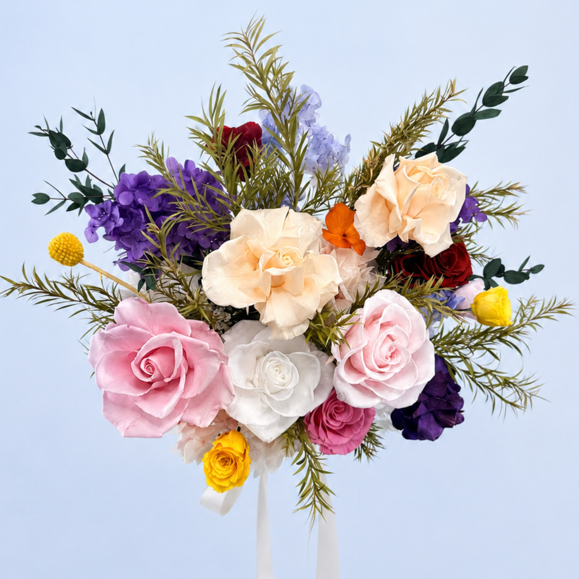 Aerial view of Rainbow Garden Preserved Flower Bouquet featuring pink, peach and red roses, purple and orange hydrangea, craspedia and eucalyptus